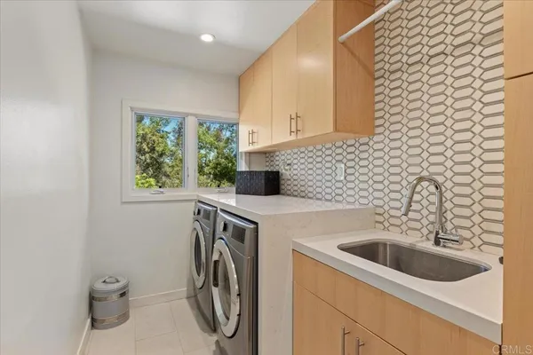 a view of a bathroom with a sink a washer and dryer