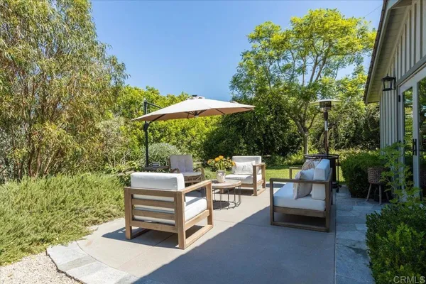 a backyard view with a seating space