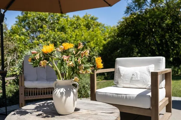 a view of outdoor sitting area with furniture and wooden floor