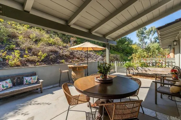 a outdoor dining space with furniture and outdoor view