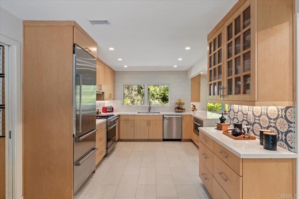 5125 El Secreto Rancho Santa Fe, CA 92067 - Photo 4 of 35 a kitchen with a sink stove and cabinets