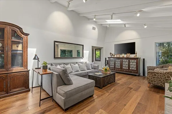 a living room with fireplace furniture and a flat screen tv