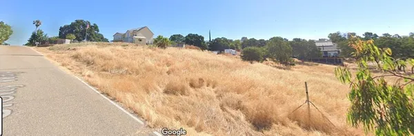 a view of a backyard of the house