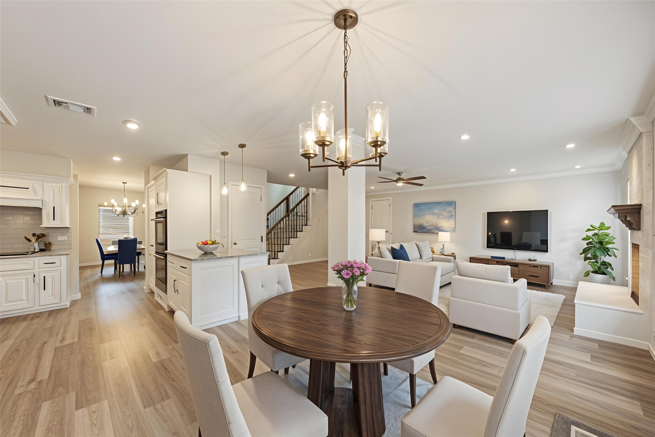 12015 Laneview Drive Houston, TX 77070 - Photo 39 of 40 a living room with furniture a dining table wooden floor and a chandelier