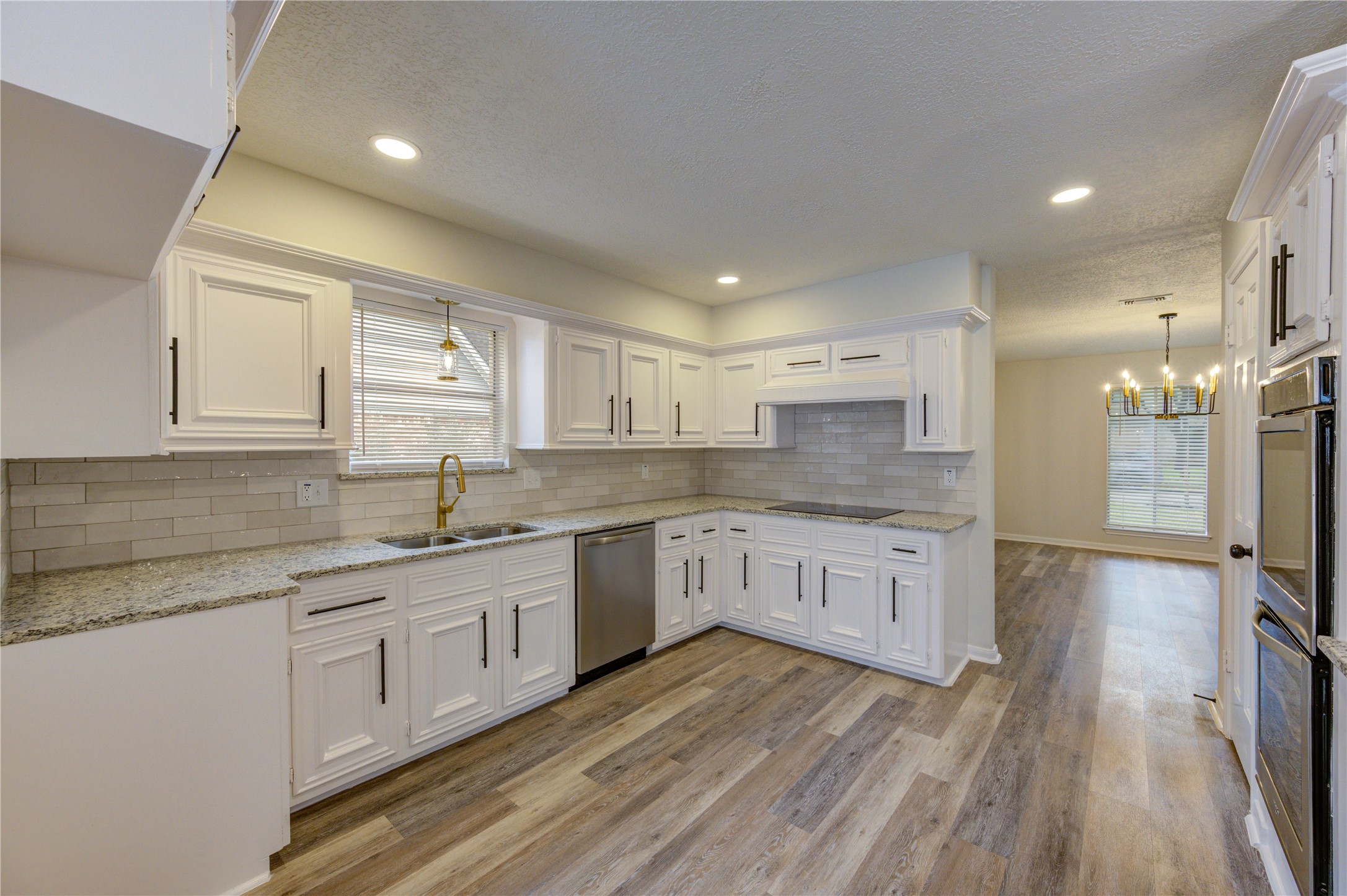 12015 Laneview Drive Houston, TX 77070 - Photo 13 of 40 a large kitchen with a lot of counter space and wooden floor