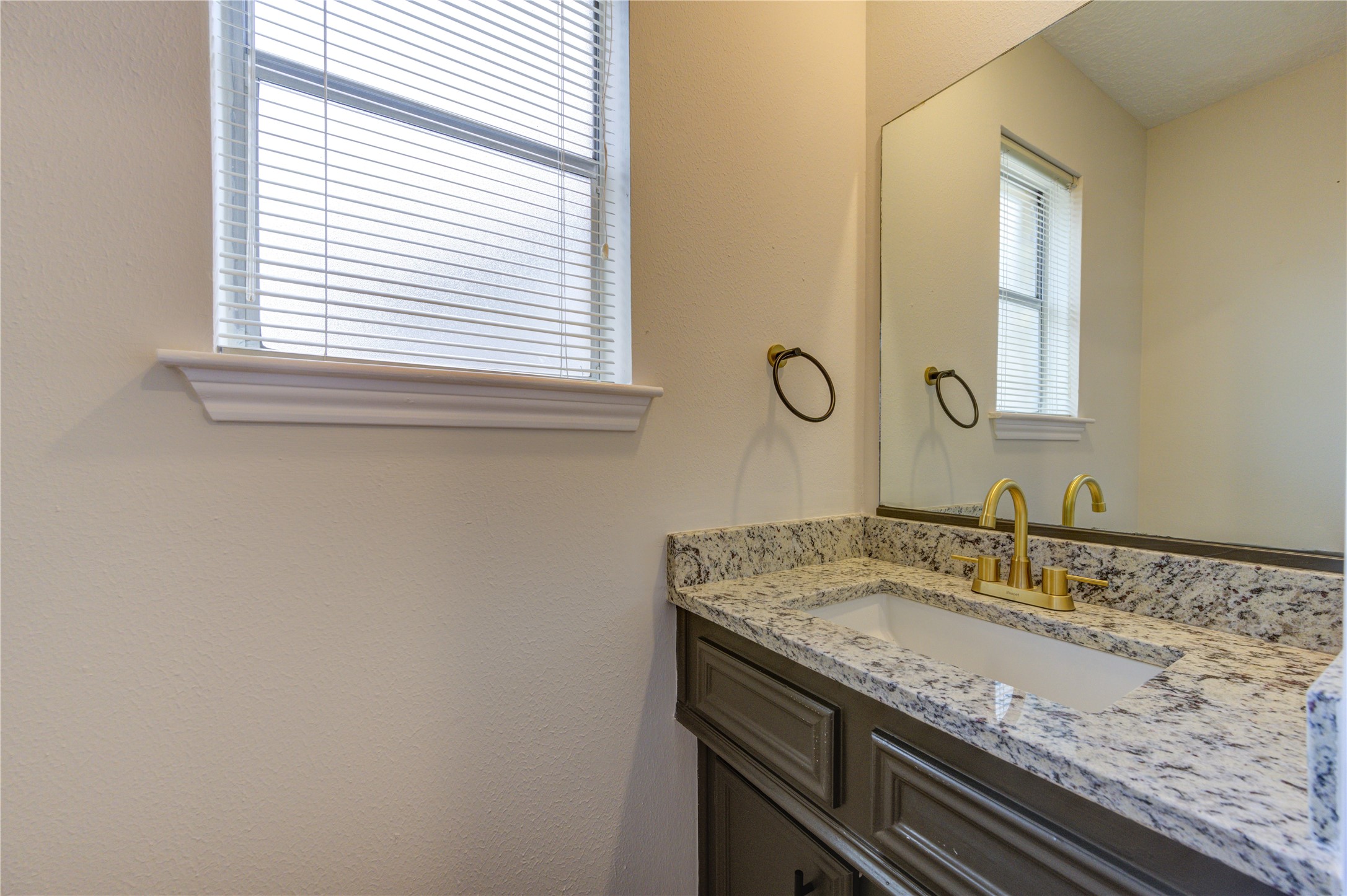 12015 Laneview Drive Houston, TX 77070 - Photo 16 of 40 a bathroom with a granite countertop sink and a window