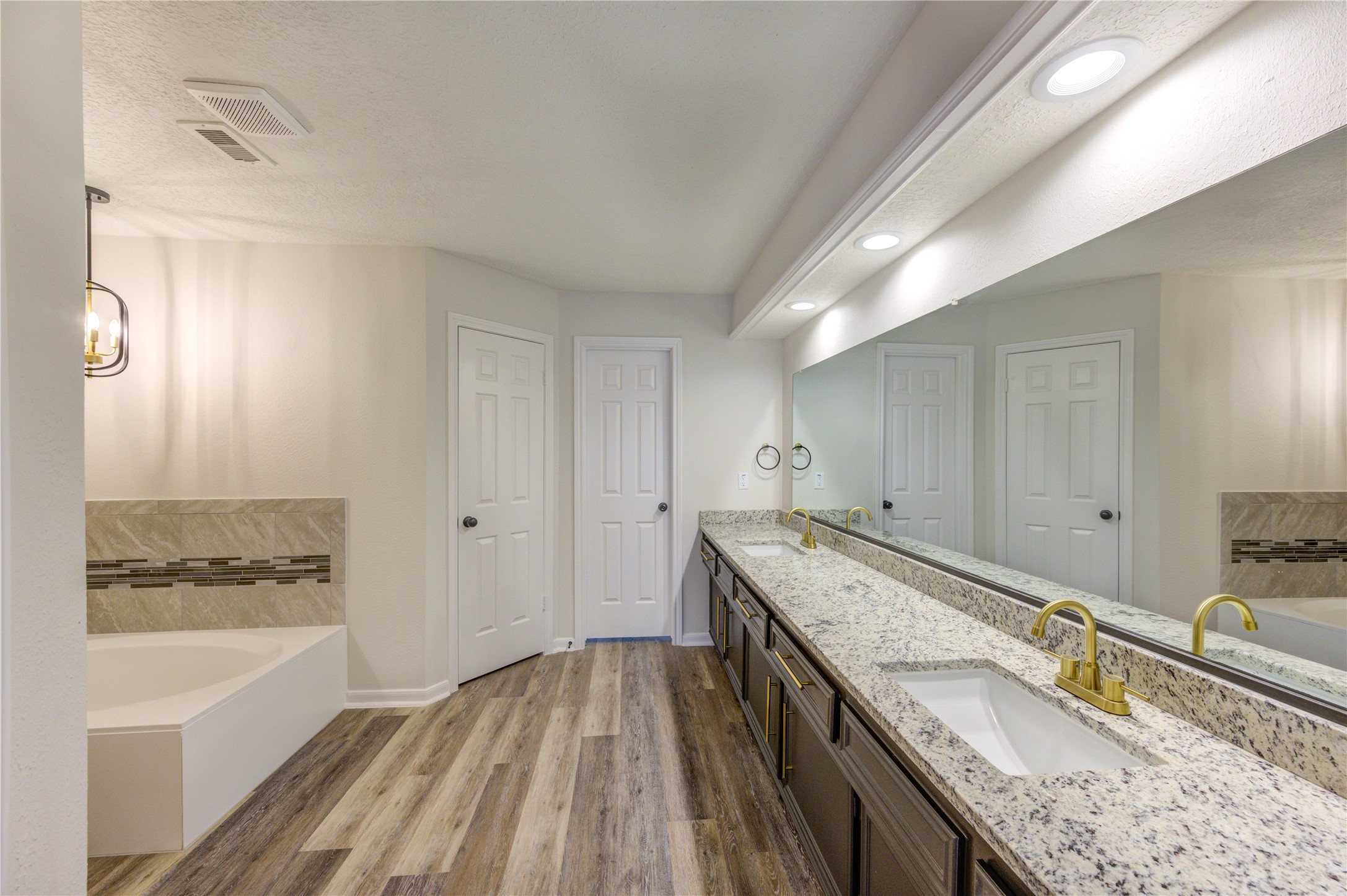 12015 Laneview Drive Houston, TX 77070 - Photo 18 of 40 a spacious bathroom with a granite countertop sink a mirror and a bathtub