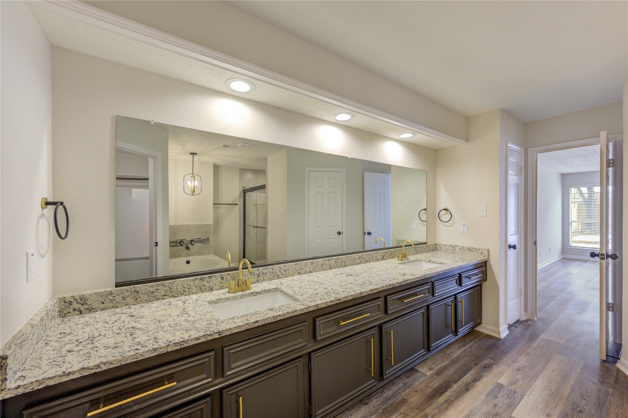 12015 Laneview Drive Houston, TX 77070 - Photo 21 of 40 a bathroom with a granite countertop sink and a large mirror