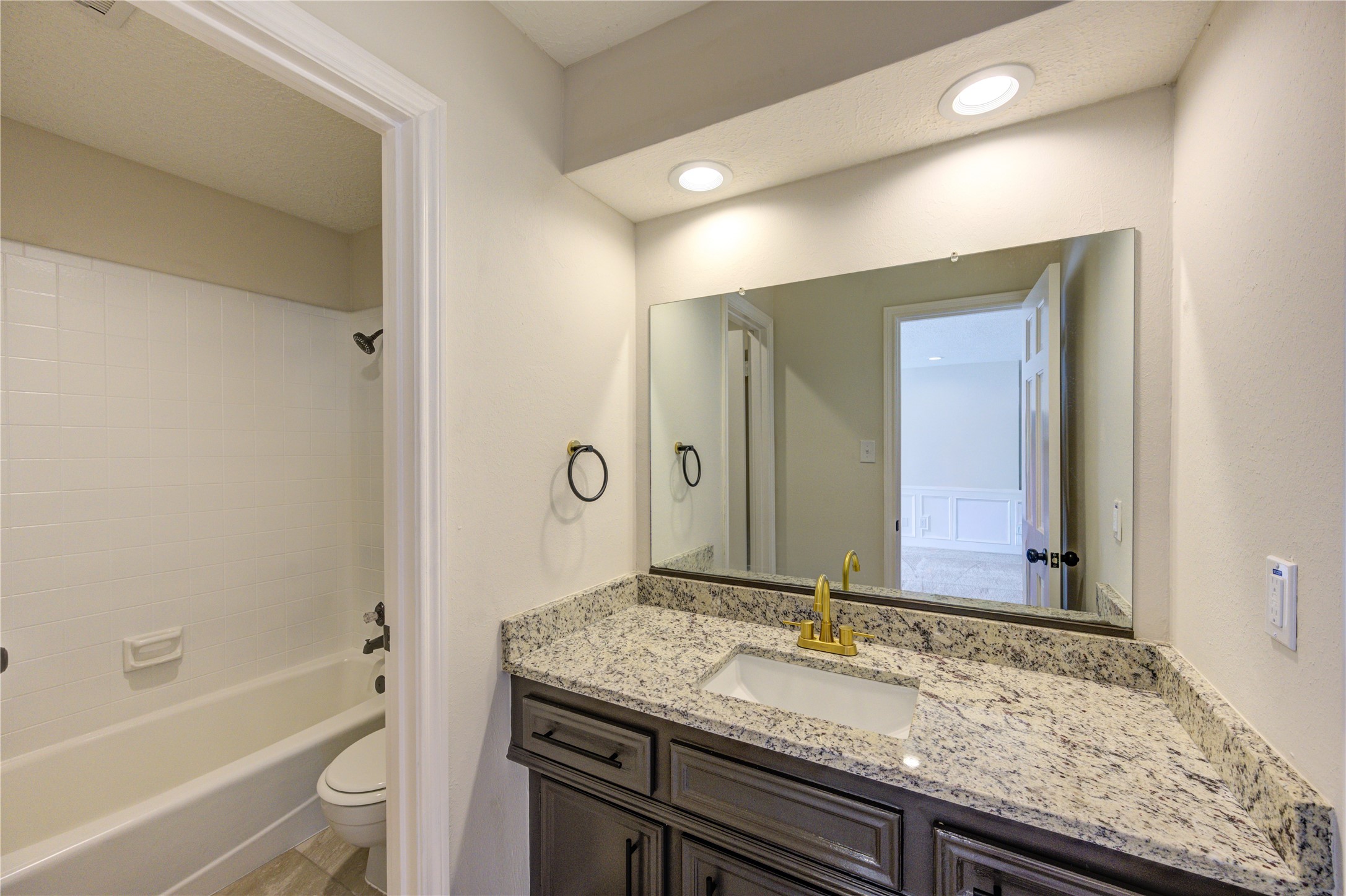12015 Laneview Drive Houston, TX 77070 - Photo 27 of 40 a bathroom with a granite countertop sink and a mirror