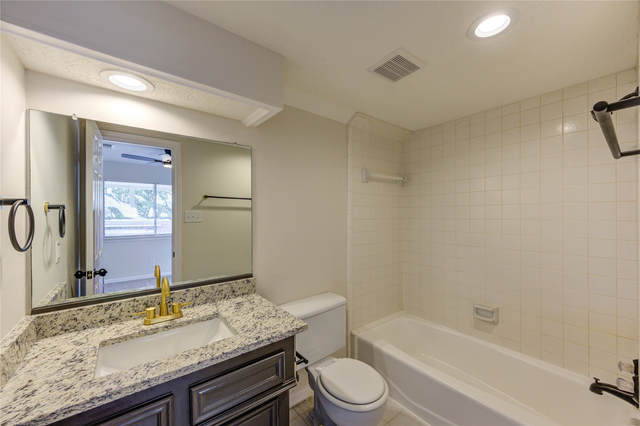 12015 Laneview Drive Houston, TX 77070 - Photo 31 of 40 a bathroom with a granite countertop sink toilet and shower