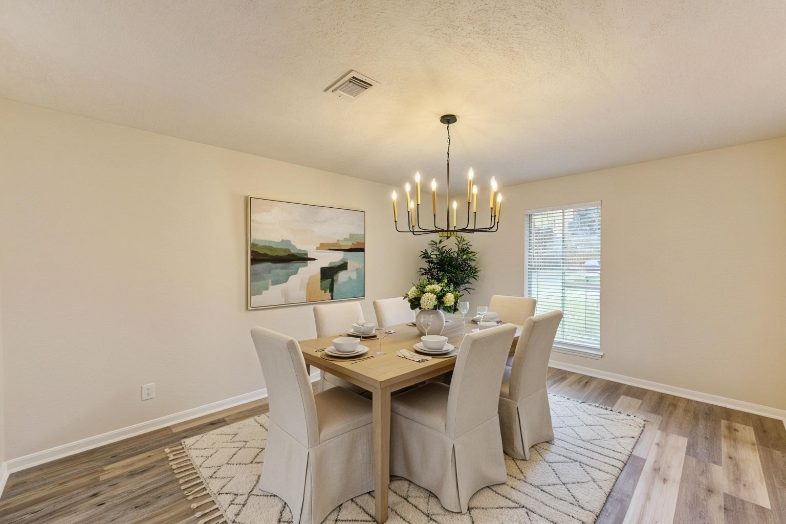 12015 Laneview Drive Houston, TX 77070 - Photo 6 of 40 a view of a dining room with furniture a chandelier and wooden floor