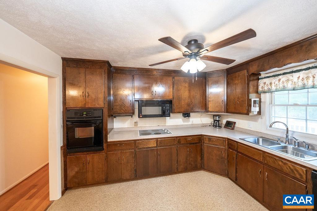 4965 Celt Road Stanardsville, VA 22973 - Photo 12 of 55 a kitchen with a sink stove and cabinets