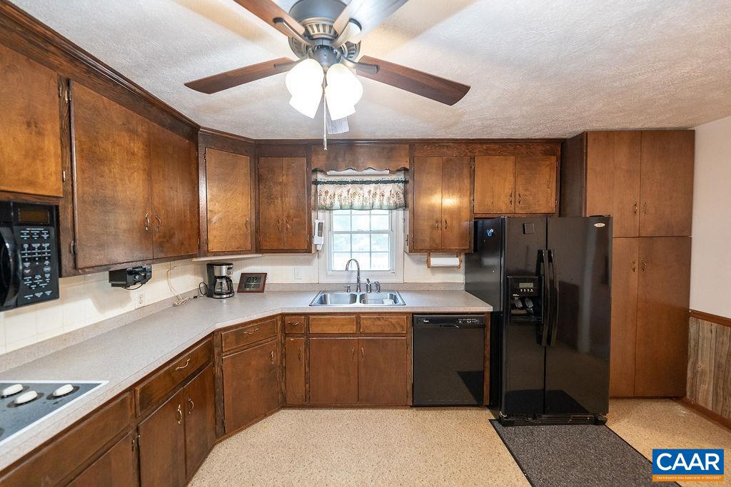 4965 Celt Road Stanardsville, VA 22973 - Photo 15 of 55 a kitchen with a sink a refrigerator and cabinets
