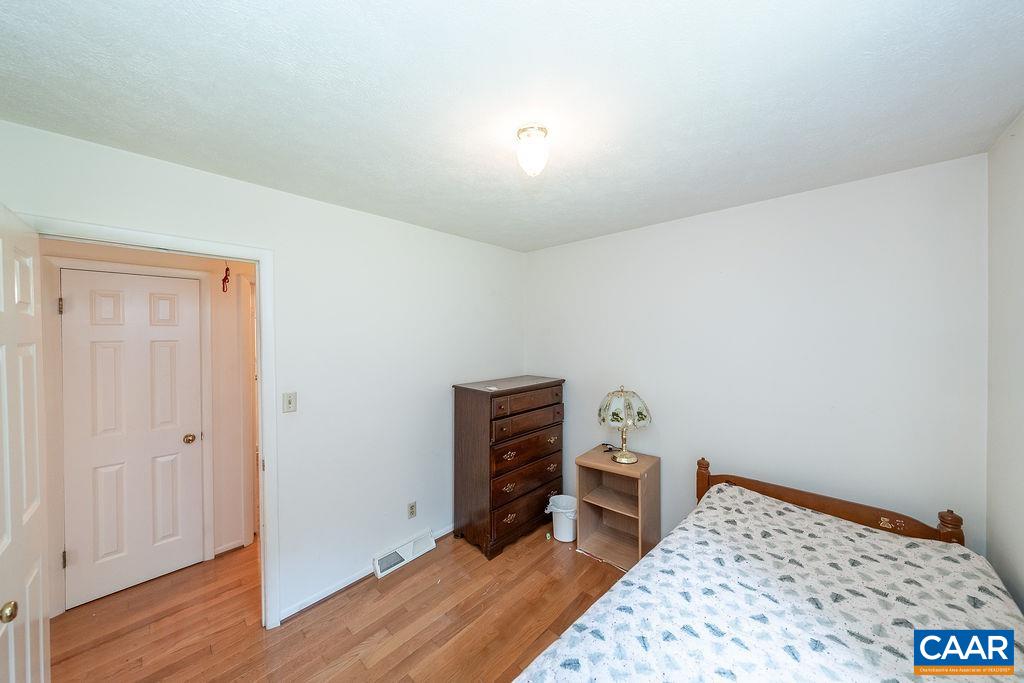 4965 Celt Road Stanardsville, VA 22973 - Photo 27 of 55 a bedroom with a bed and wooden floor