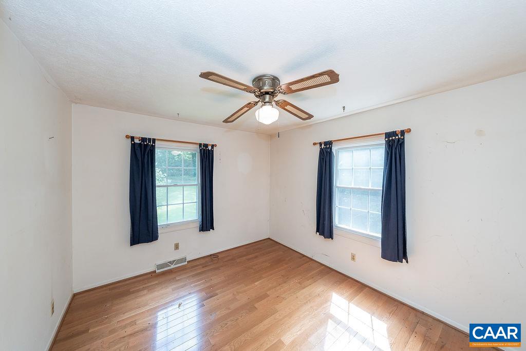 4965 Celt Road Stanardsville, VA 22973 - Photo 30 of 55 a view of a livingroom with a window and a ceiling fan