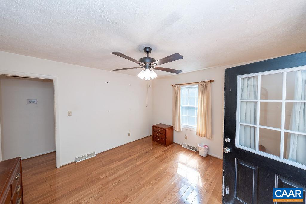 4965 Celt Road Stanardsville, VA 22973 - Photo 35 of 55 an empty room with wooden floor and windows