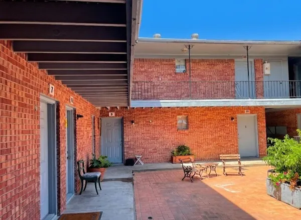 a brick building with a bench in front of it