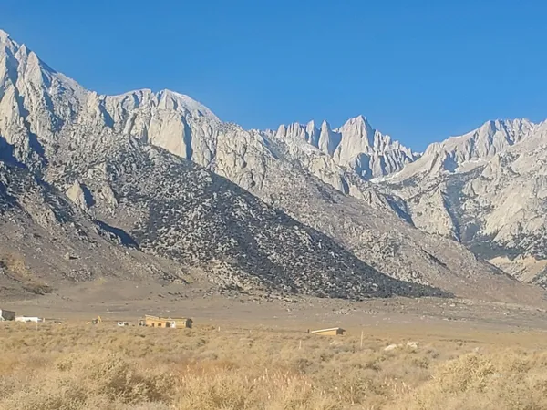 a view of mountain with a field
