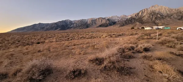 a view of a large mountain with snow in the background