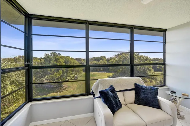a view of a living room and floor to ceiling window