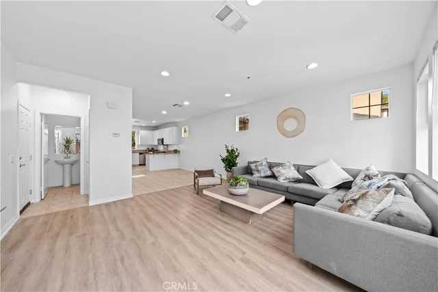 a living room with furniture and kitchen view