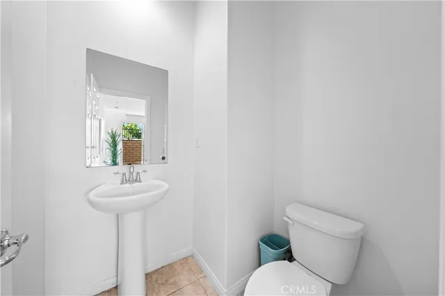 a bathroom with a sink mirror and toilet