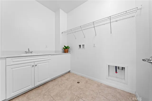 a room with a sink and cabinets