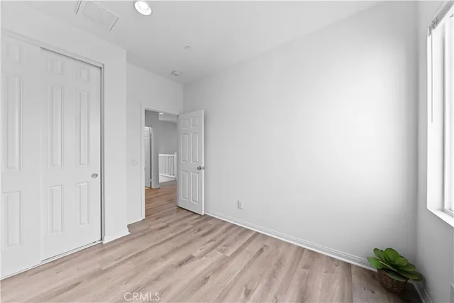 a view of an empty room and wooden floor