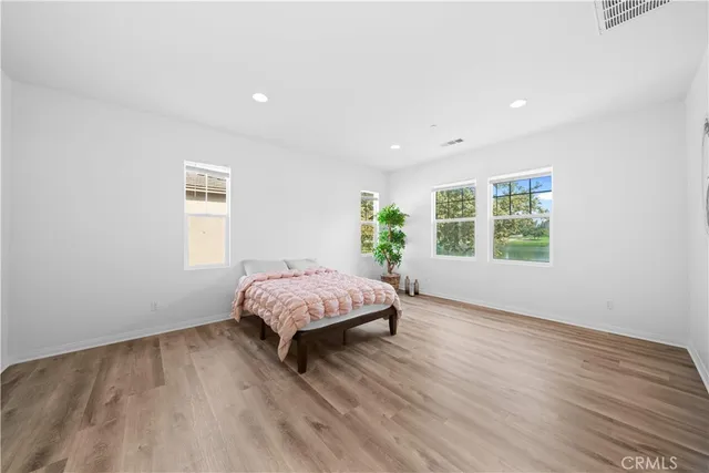 a bedroom with a bed and a potted plant