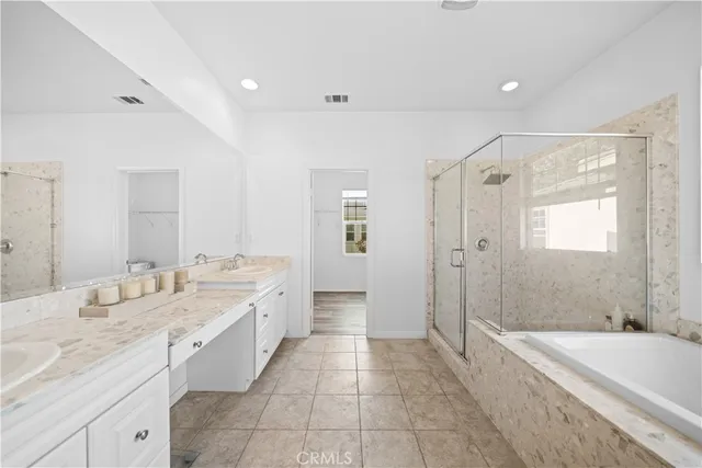 a spacious bathroom with a tub shower and mirror
