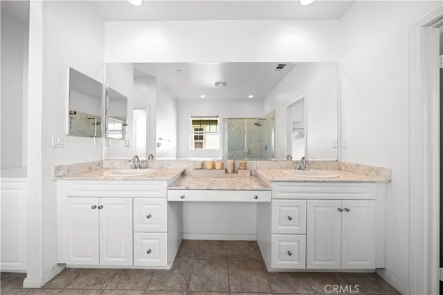 a view of an empty room with closet and wooden floor