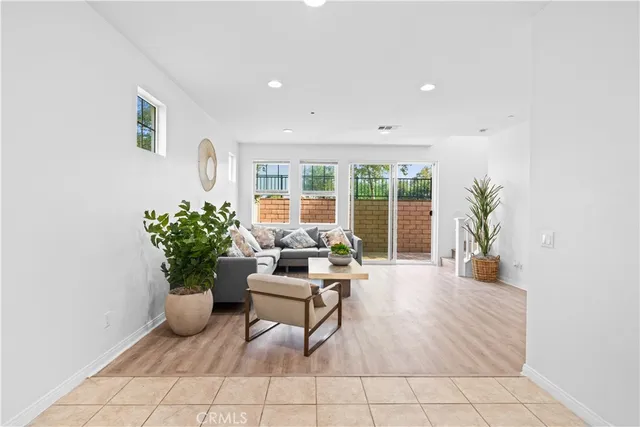 a living room with furniture and a potted plant
