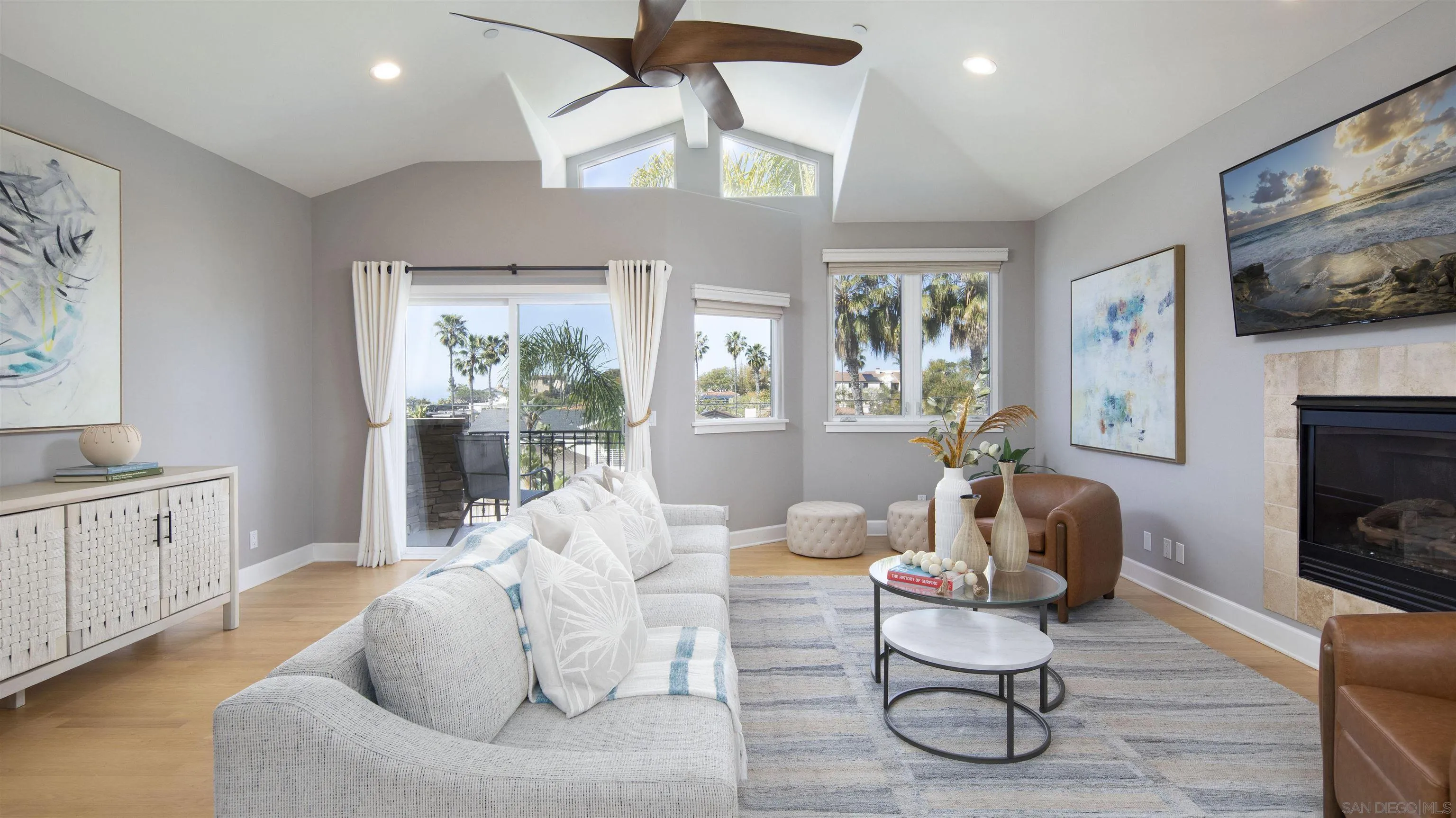 a living room with furniture fireplace and a large window