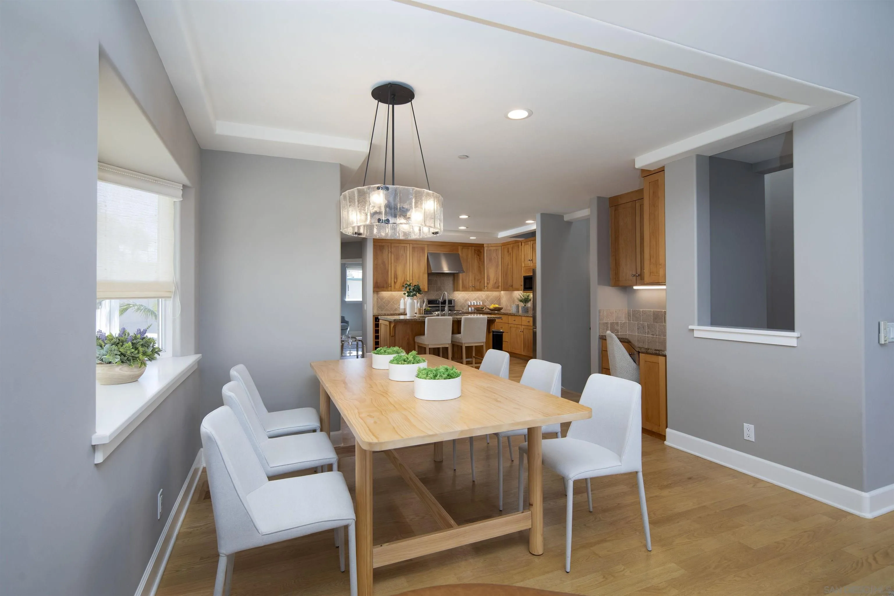 145 3rd Street Encinitas, CA 92024 - Photo 16 of 34 a view of a dining room with furniture a chandelier and wooden floor