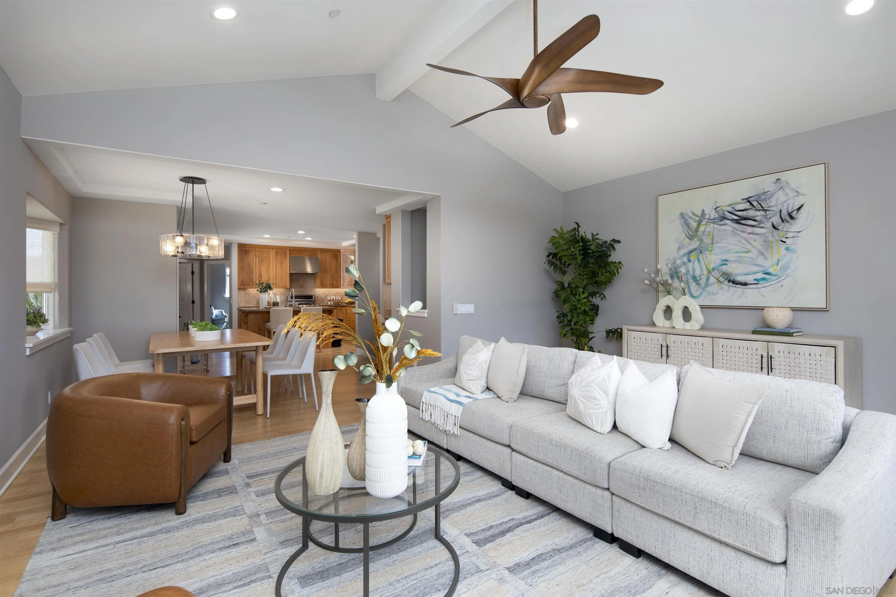 145 3rd Street Encinitas, CA 92024 - Photo 10 of 34 a living room with furniture kitchen view and a chandelier