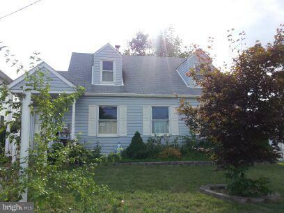 3116 Sollers Point Road Baltimore, MD 21222 - Photo 1 of 8 a front view of a house with a garden