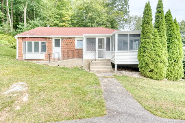 a front view of a house with a garden
