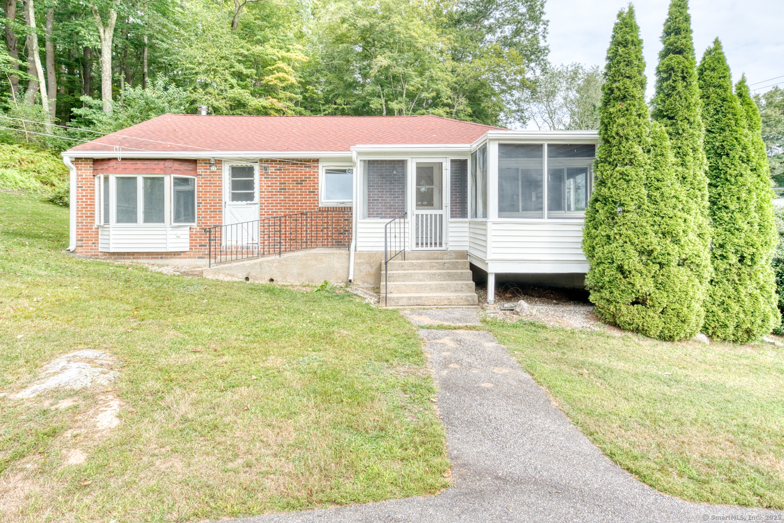 a front view of a house with a garden