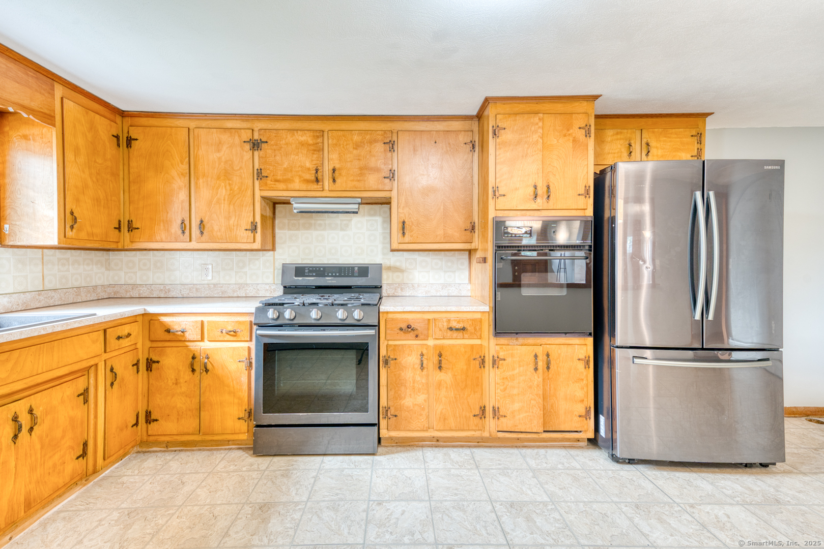 26 Edgarton Road Columbia, CT 06237 - Photo 16 of 35 a kitchen with stainless steel appliances granite countertop a refrigerator and a stove top oven