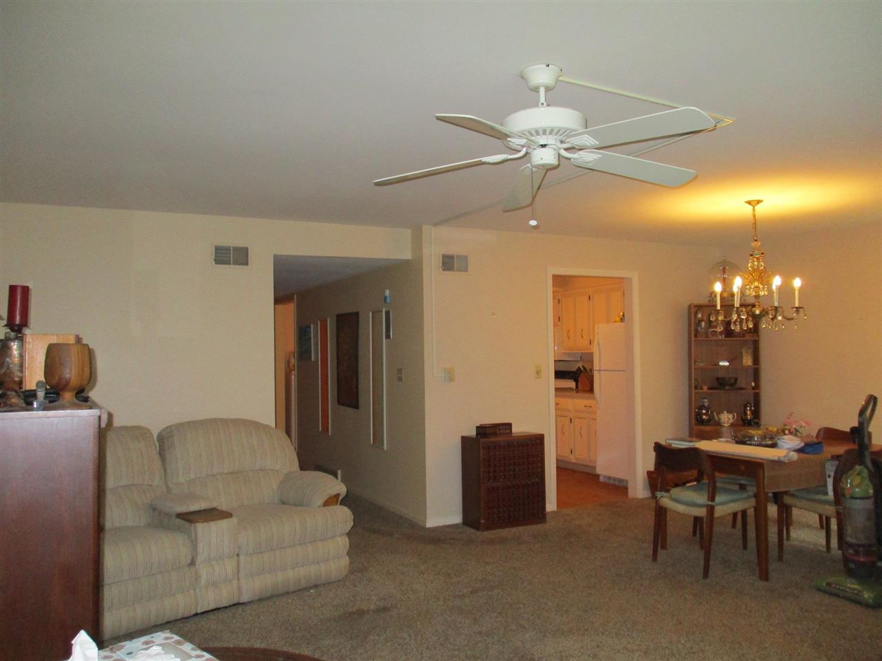 5548 Spring Brook Road, Unit G1 Rockford, IL 61114 - Photo 11 of 15 a living room with furniture a chandelier and a dining table