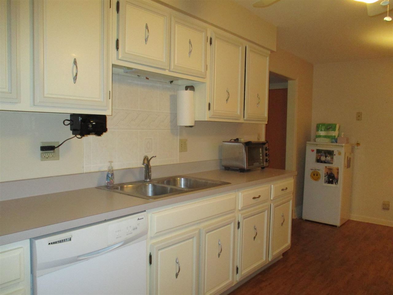 5548 Spring Brook Road, Unit G1 Rockford, IL 61114 - Photo 6 of 15 a kitchen with white cabinets and sink
