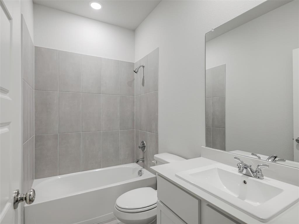 1136 Del Rio Drive Lavon, TX 75166 - Photo 22 of 30 Bathroom featuring a white vanity with integrated sink, chrome faucet, and a large wall-mounted mirror