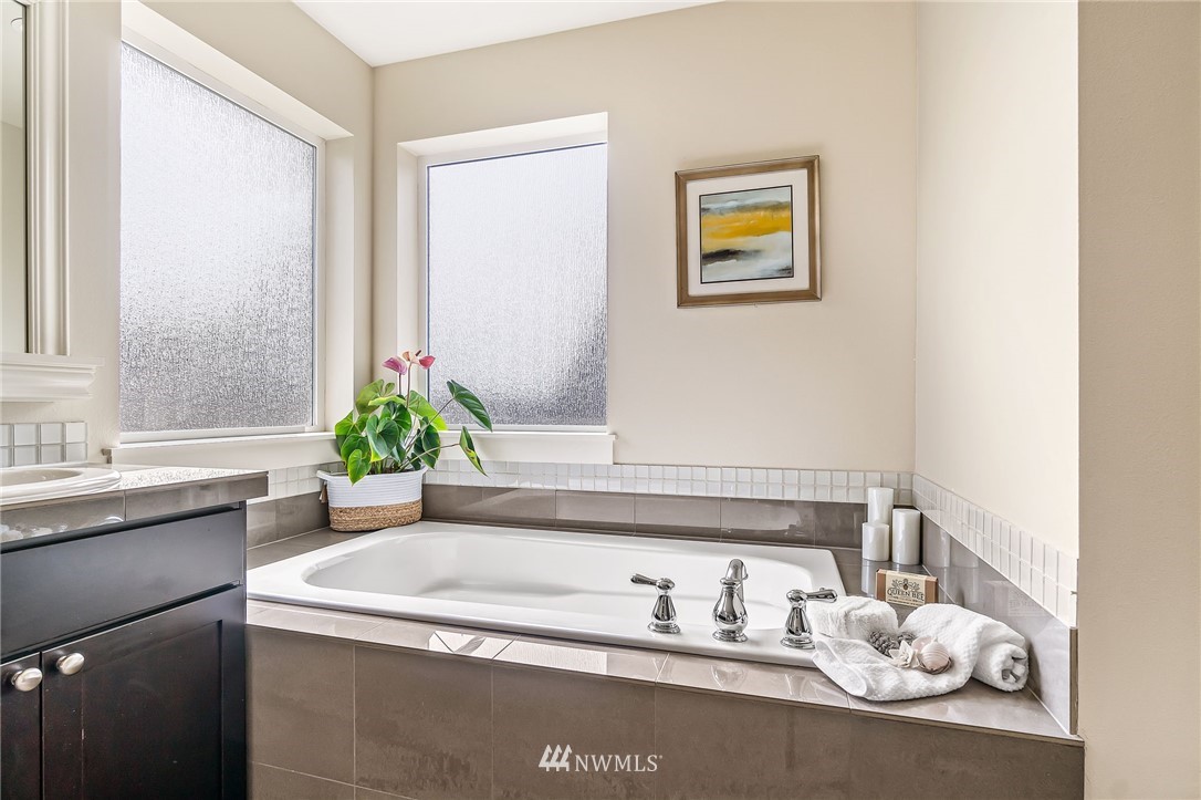 4110 177th Street Southeast Bothell, WA 98012 - Photo 22 of 39 a bathroom with a granite countertop sink and a mirror