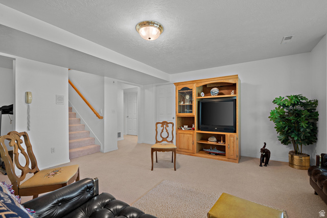 166 South Ridgeview Drive Orem, UT 84058 - Photo 25 of 38 Neutral wall paint, recessed lighting, wood handrailing, built-in media cabinetry, and carpet flooring