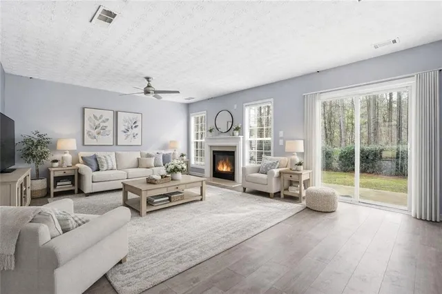 a living room with furniture a fireplace and a flat screen tv