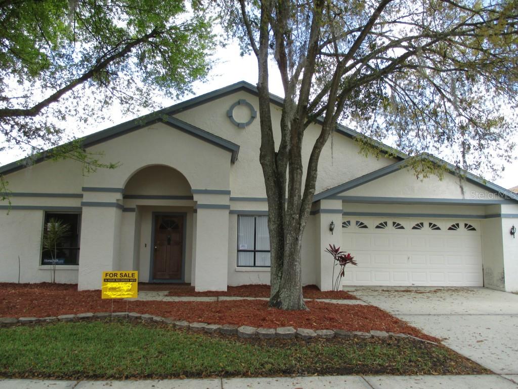 9725 Fox Chapel Road Tampa, FL 33647 - Photo 1 of 1 a front view of a house with garden