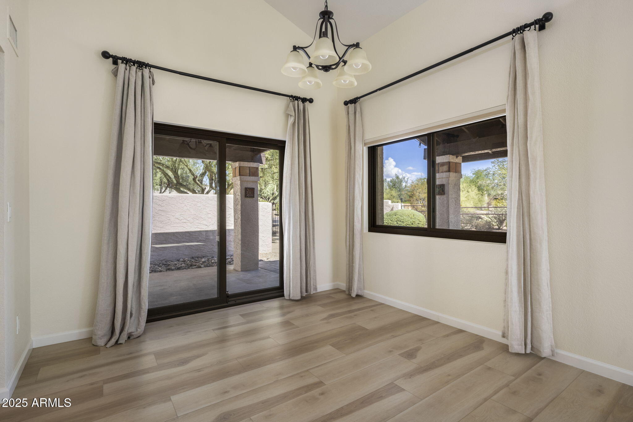 18560 East Horseshoe Bend Rio Verde, AZ 85263 - Photo 12 of 42 an empty room with wooden floor cabinet and windows