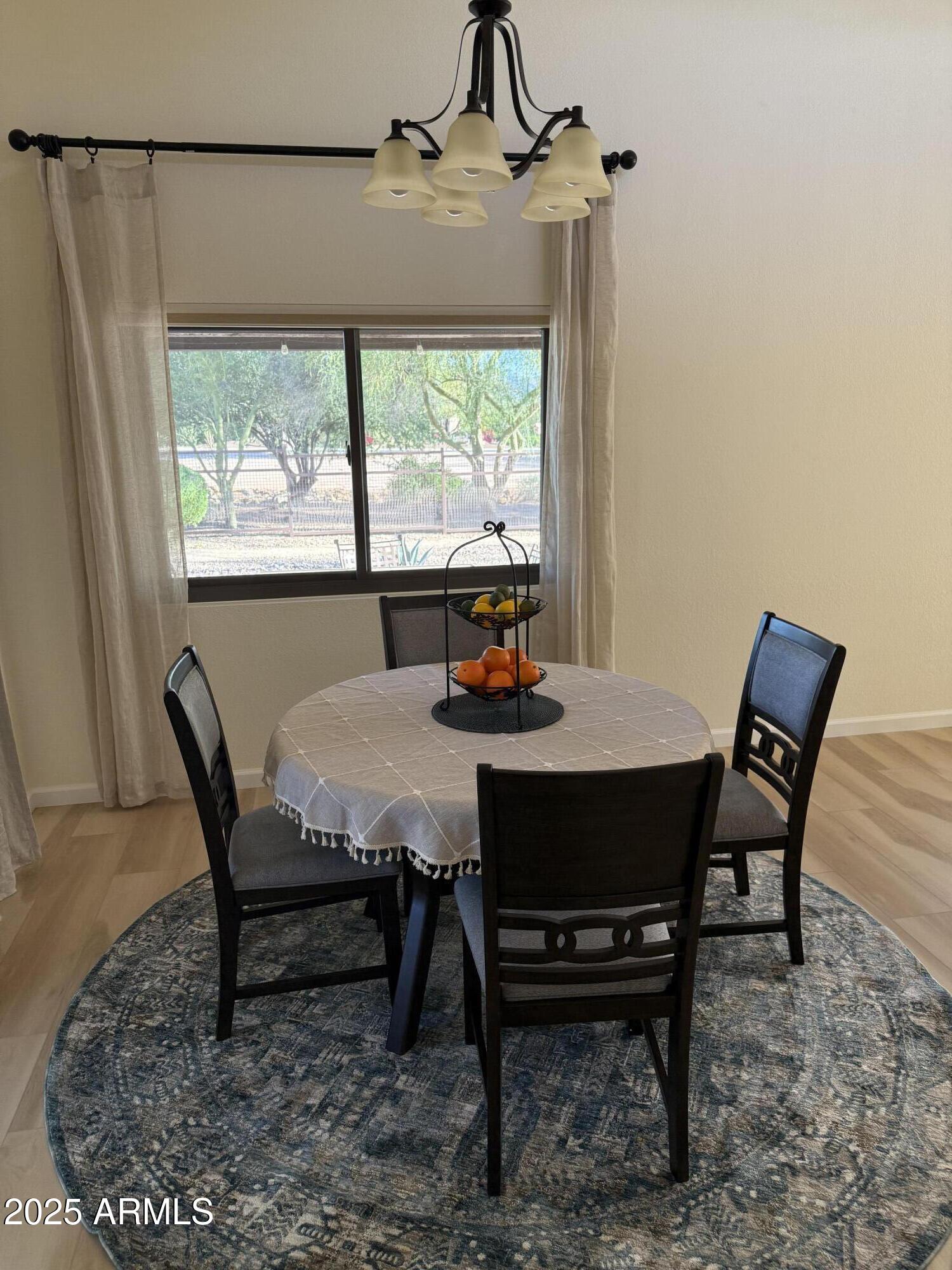 18560 East Horseshoe Bend Rio Verde, AZ 85263 - Photo 13 of 42 a dining room with furniture a rug and a floor to ceiling window