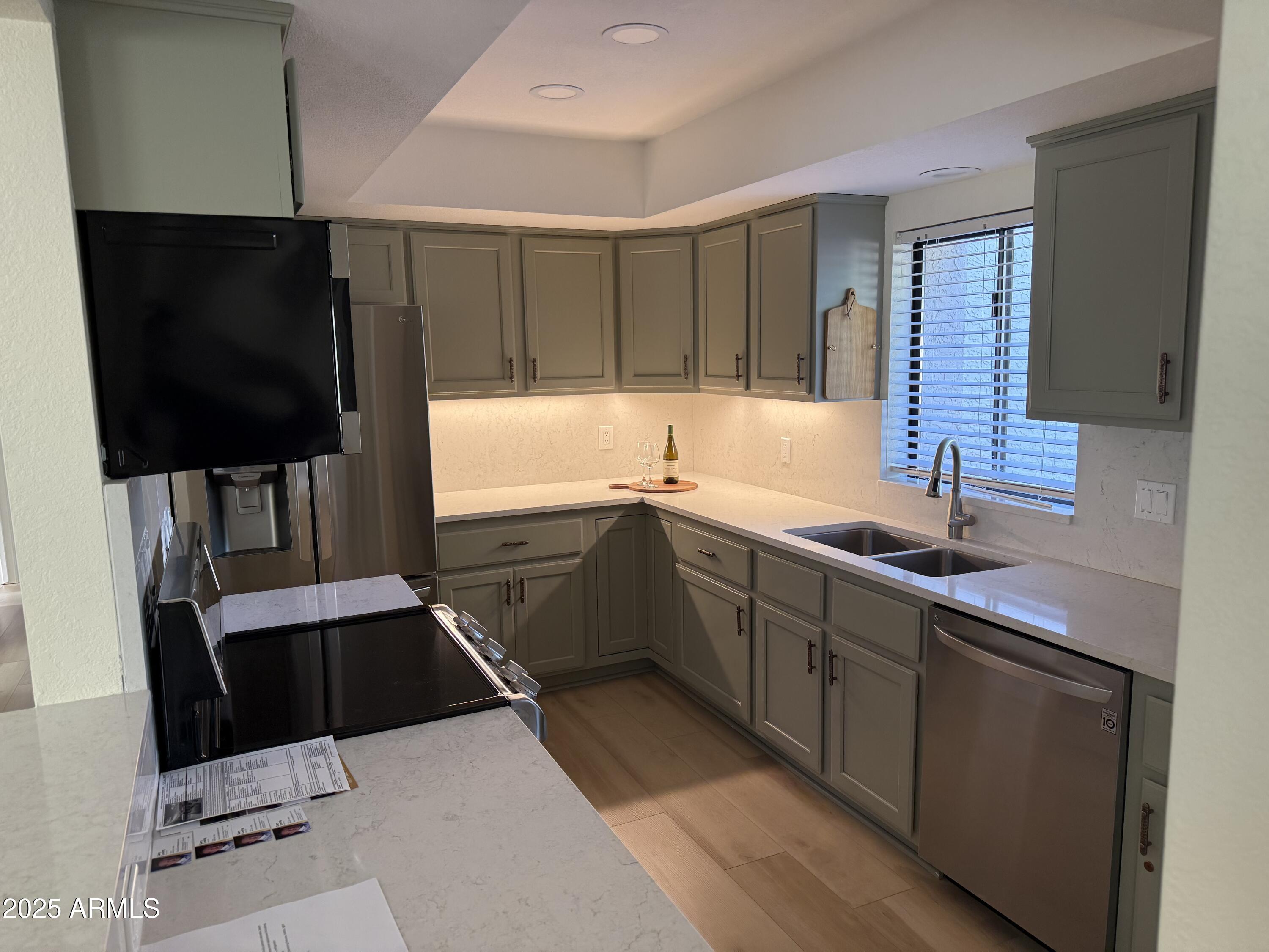 18560 East Horseshoe Bend Rio Verde, AZ 85263 - Photo 18 of 42 a kitchen with a sink a counter top space cabinets and stainless steel appliances