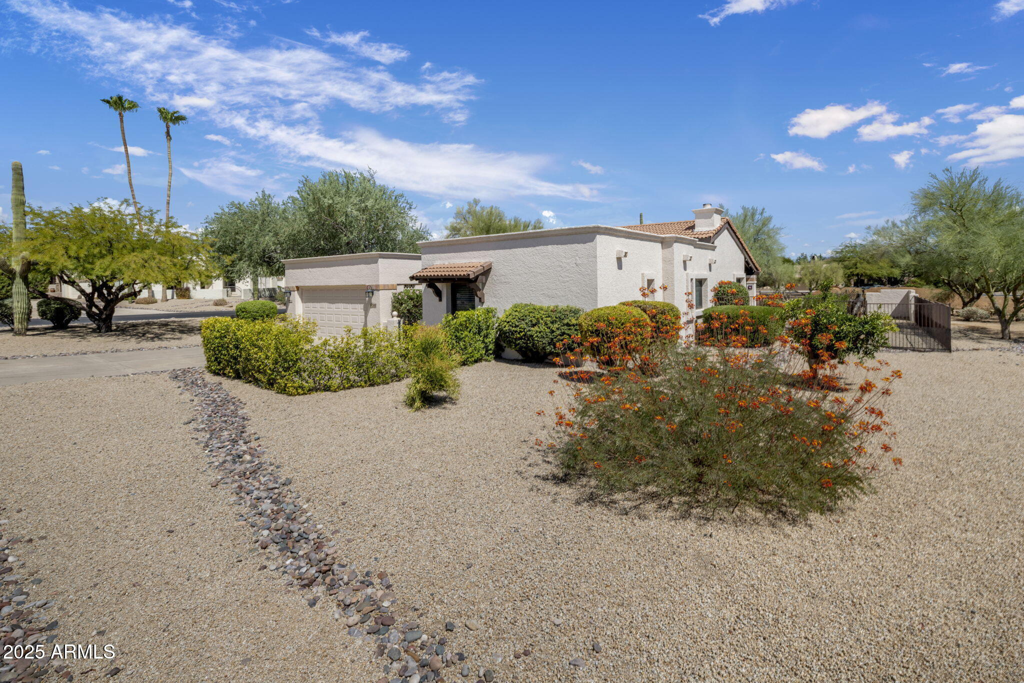 18560 East Horseshoe Bend Rio Verde, AZ 85263 - Photo 4 of 42 a front view of a house with a yard and outdoor seating